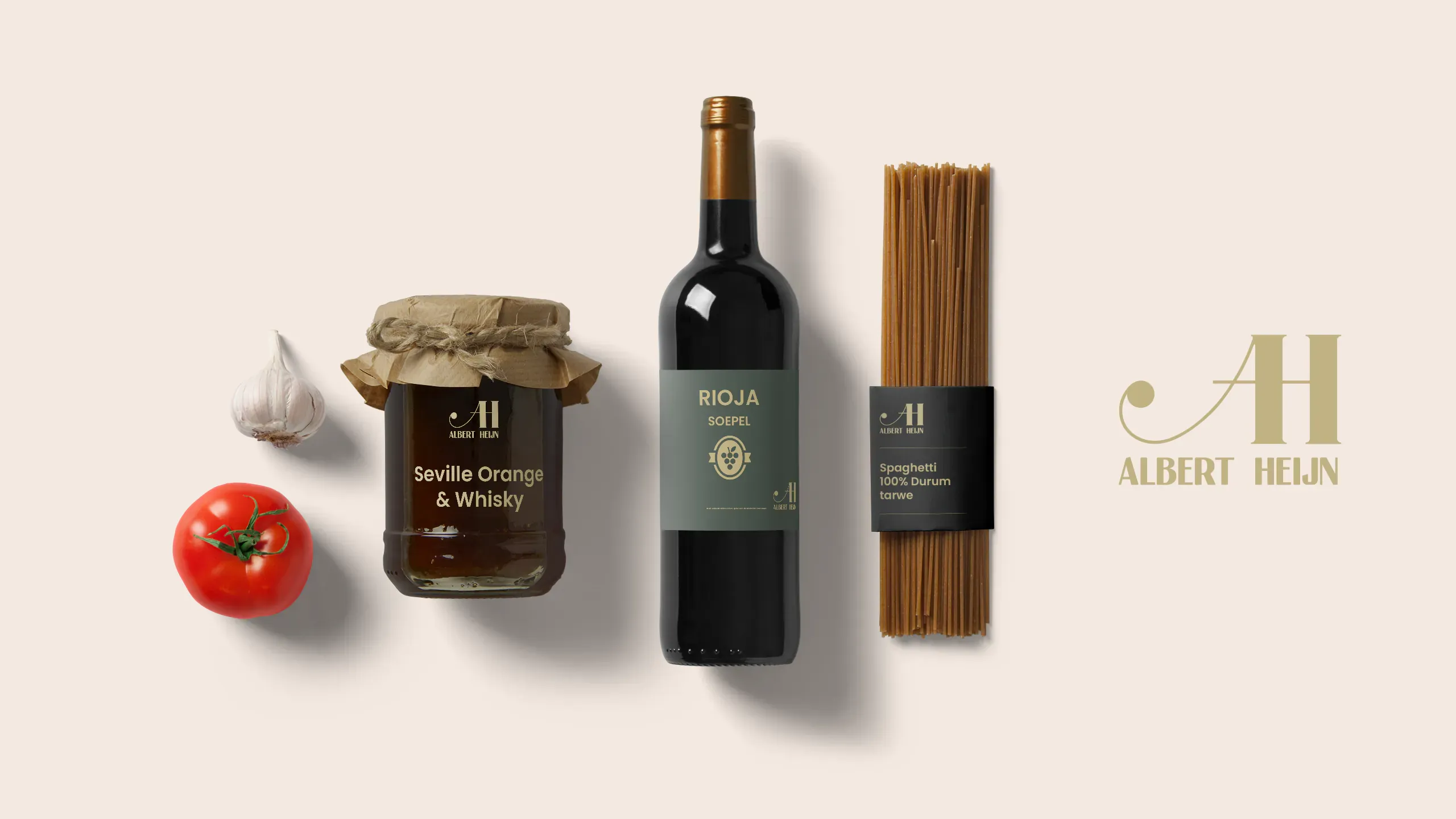 AH artisanal outcome A — three products (jam jar, wine bottle, pasta) on cream with an elegant serif 'AH' monogram in gold: a heritage-forward, classic response to the brief
